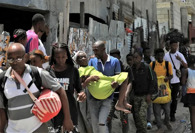 People carry their belongings as they flee their neighbourhood Carrefour Feuilless after gangs took over, in Port-au-Prince, Haiti on August 15, 2023. (Photo by Ralph Tedy Erol/Reuters)