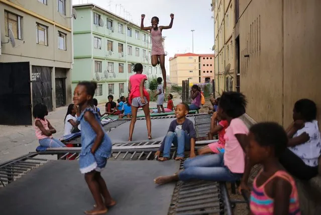 Young children jump on one of the trampolines at the Alexandra Trampoline Club in Johannesburg, South Africa, December 1, 2016. The children jump after school each day as one of the rare extra activities in one of Johannesburg oldest and most impoverished townships. (Photo by Kim Ludbrook/EPA)