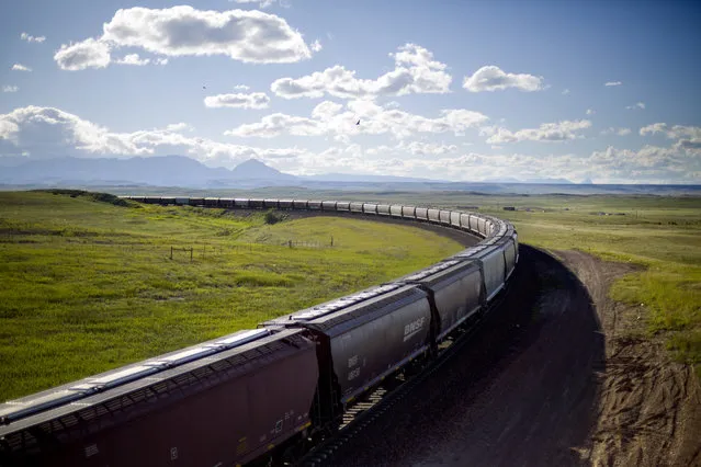 A train rounds a bend while traveling across the landscape of the Blackfeet Indian Reservation in Browning, Mont., Tuesday, July 10, 2018. Tribal police and investigators from the federal Bureau of Indian Affairs serve as law enforcement on reservations, which are sovereign nations. But the FBI and U.S. Department of Justice investigate certain offenses and, if there's ample evidence, prosecute major felonies such as murder, kidnapping and rape if they happen on tribal lands. (Photo by David Goldman/AP Photo)