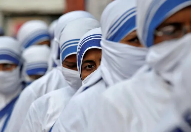 Catholic nuns from the Missionaries of Charity, the global order of nuns founded by Saint Mother Teresa, wait in a line to cast their vote outside a polling station during the eight and final phase of West Bengal state election, amid the spread of the coronavirus disease (COVID-19) in Kolkata, India, April 29, 2021. (Photo by Rupak De Chowdhuri/Reuters)