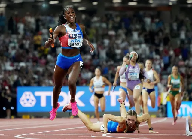 Alexis Holmes of Team United States crosses the finish line to win the 4x400m Mixed Relay Final as Femke Bol of Team Netherlands falls during day one of the World Athletics Championships Budapest 2023 at National Athletics Centre on August 19, 2023 in Budapest, Hungary. (Photo by Sarah Meyssonnier/Reuters)