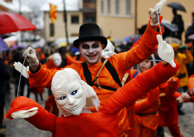 Revellers participate in a parade on the street during a carnival in the village of Vevcani, south of Skopje, Macedonia January 13, 2016. (Photo by Ognen Teofilovski/Reuters)