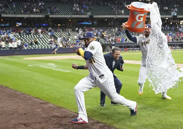 Milwaukee Brewers' Carlos Santana dodges being doused by Willy Adames after the team's win over the Philadelphia Phillies in a baseball game in Milwaukee, Saturday, September 2, 2023. (Photo by Kayla Wolf/AP Photo)