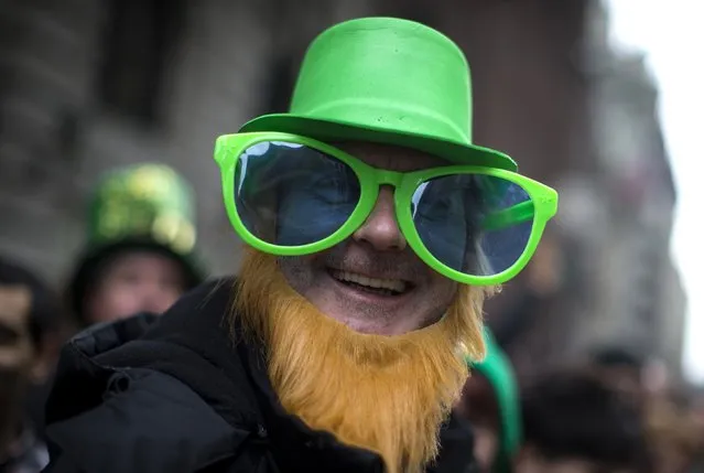 Carl McCormack from Scotland wears a St. Patrick's Day costume as he stands with thousands of spectators to watch the 254th New York City St. Patrick's Day parade up 5th Avenue in the Manhattan Borough of New York, March 17, 2015. (Photo by Mike Segar/Reuters)