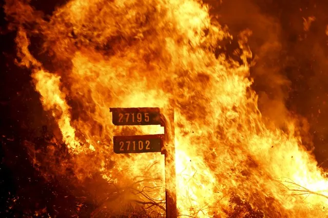 Flames from the Jerusalem Fire consume a sign containing addresses to homes along Morgan Valley Road in Lake County, California in this August 12, 2015 file photo. (Photo by Robert Galbraith/Reuters)