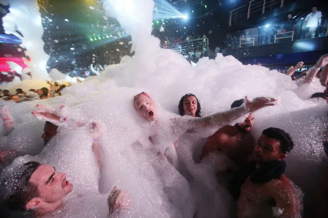 Spring Breakers are covered in foam at The City nightclub in the Caribbean resort city of Cancun, Mexico, early Monday, March 16, 2015. Cancun continues to be one of the top foreign destinations for U.S. college students to spend Spring Break. (Photo by Israel Leal/AP Photo)