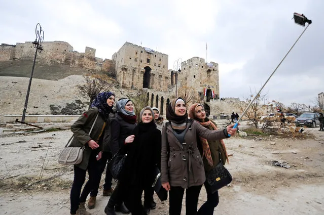 Women take a selfie outside Aleppo's historic citadel, in the government controlled area of the city, Syria December 17, 2016. (Photo by Omar Sanadiki/Reuters)