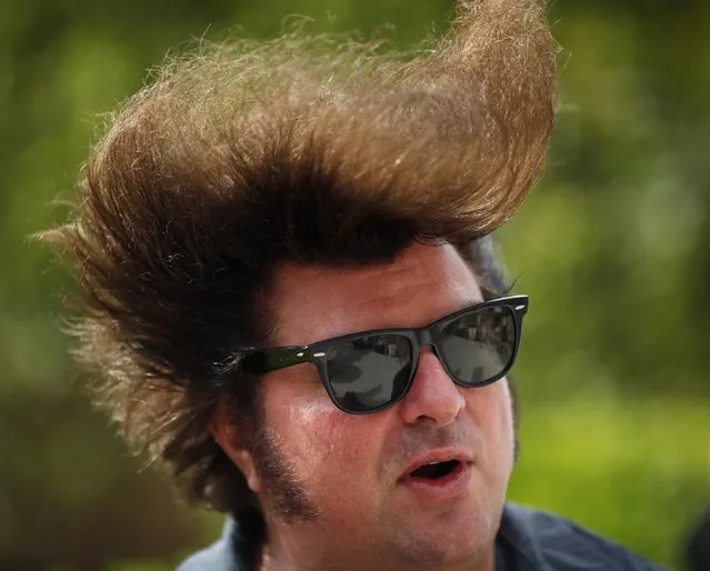 In this April 5, 2015, photo, wind blows the hair of Carl Schreiber, of Chicago, during a pool party at the Viva Las Vegas Rockabilly Weekend in Las Vegas. (Photo by John Locher/AP Photo)