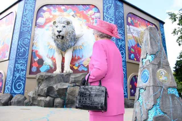 A Queen Elizabeth lookalike walks past the Flight of the Sky Lion experience at Legoland Windsor Resort in United Kingdom on August 9, 2021. (Photo by Jonathan Hordle/Rex Features/Shutterstock)
