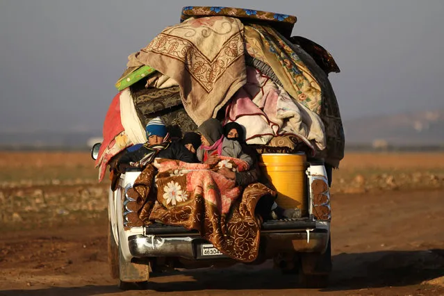 People ride a vehicle stacked with their belongings after fleeing clashes in the northern Syrian town of al-Bab, Syria January 7, 2017. (Photo by Khalil Ashawi/Reuters)