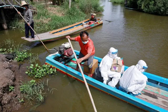Public health officers Charoenrat Chaibut and Jurairat Tasom travel by boat to bring coronavirus disease (COVID-19) swab testing to residents living in remote communities, amid the rise of coronavirus disease infections, in Samut Prakan, near Bangkok, Thailand, July 19, 2021. (Photo by Soe Zeya Tun/Reuters)