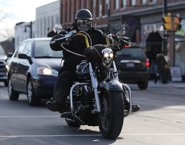 A masked biker cruises down Main Street during a below-freezing Friday the 13th motorcycle rally in Port Dover, Ontario, Canada January 13, 2017. For the event which is held in all seasons, the temperatures in Port Dover on Friday ranged from a low of minus five degrees Celcius (23 degrees Fahrenheit) to a high of minus one degree Celcius (30 degrees Fahrenheit) and with a windchill of  minus 11 degrees Celcius (12 degrees Fahrenheit). (Photo by Peter Power/Reuters)