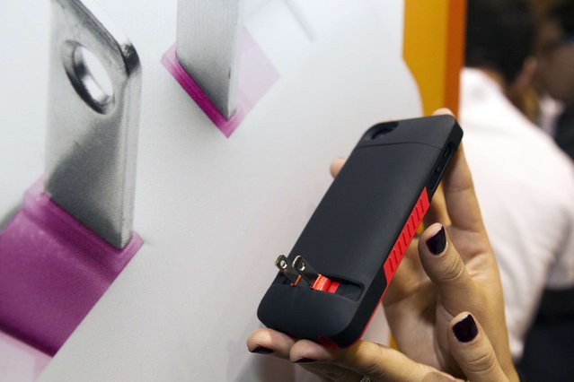 A Prong iPhone case is displayed during “CES Unveiled”, a media preview event to the annual Consumer Electronics Show (CES), in Las Vegas, Nevada, January 5, 2014. The case has a fold-out plug that allows the phone to plug directly into the outlet. The cases retail for $59.95- $69.95 depending on the model. (Photo by Steve Marcus/Reuters)