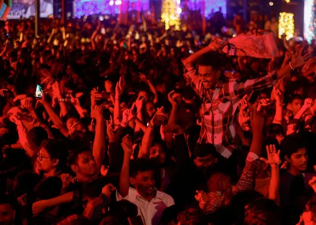 People dance during a party on New Year's eve in Mumbai, India on December 31, 2023. (Photo by Francis Mascarenhas/Reuters)