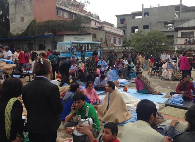 Patients wait at the parking lot of Norvic International Hospital after an earthquake hit Kathmandu, Nepal, Saturday, April 25, 2015. (Photo by Binaj Gurubacharya/AP Photo)