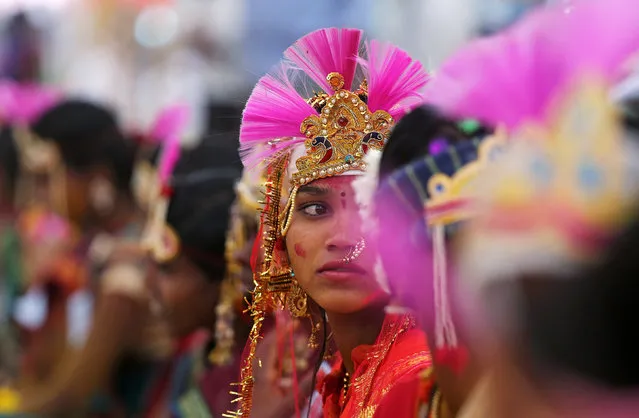 A bride looks on as she and others wait to take their wedding vows during a tribal mass marriage ceremony, in which 1101 couples took part, on the outskirts of Mumbai, India, February 17, 2019. (Photo by Francis Mascarenhas/Reuters)