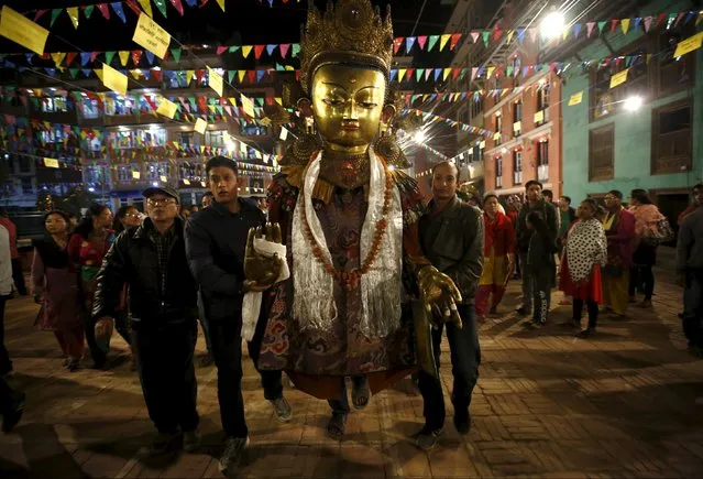 An idol of Buddha is brought in to Patan during the Samyak festival in Lalitpur, Nepal, March 11, 2016. (Photo by Navesh Chitrakar/Reuters)