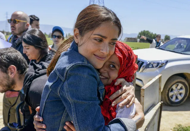In this Saturday, April 25, 2015, picture provided by UNICEF, Mexican and American actress Salma Hayek hugs a Syrian refugee girl during her visit at Saadnayz UNICEF protection center in the Bekaa Valley, Lebanon. Hayek is in Lebanon for “The Prophet”, an animated feature film she co-produced, which was written and directed by Roger Allers, the maker of the Disney production The Lion King. The film tells the story of a young girl who finds the voice she lost through her friendship with a poet imprisoned for his ideas. (Photo by Sebastian Rich/ UNICEF via AP Photo)