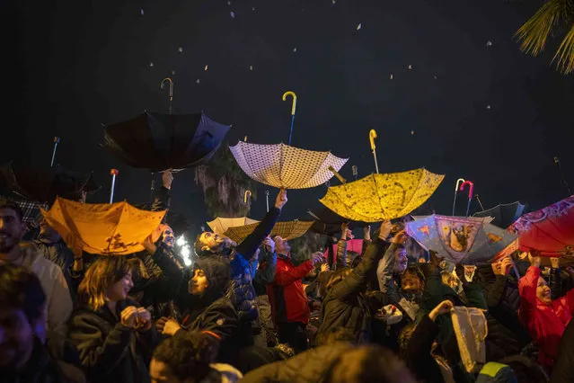 People rise their umbrellas to get candies during the “Cabalgata de Reyes” Epiphany parade in Barcelona, Spain, Friday, January 5, 2024. Christians around the world will mark the Epiphany on Jan. 6 with a series of celebrations that go from parades and gift-giving for children to the blessing of water. The holiday is also called the Feast of Epiphany, Three Kings Day and Theophany. (Photo by Emilio Morenatti/AP Photo)