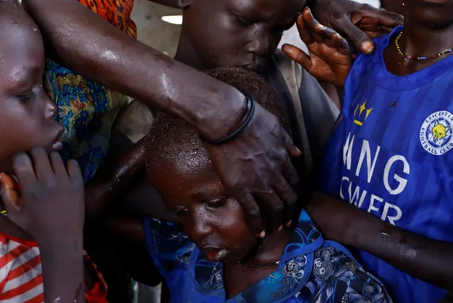 Nyagonga Machul, 38, embraces her children (L-R) Nyameer Mario, 6, Nyawan Mario, 4, Ruai Mario, 10, and Machiey Mario, 8, after being reunited with them at the United Nations Mission in South Sudan (UNMISS) Protection of Civilian site (CoP) in Juba, South Sudan, February 13, 2017. (Photo by Siegfried Modola/Reuters)