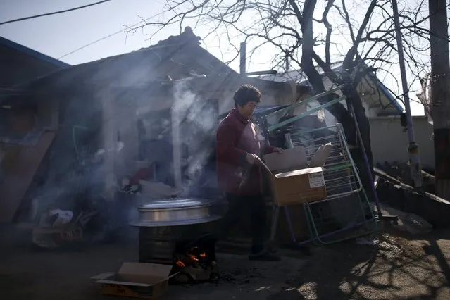 A woman cooks at a border village just south of the demilitarized zone where loudspeakers are installed, in Yeoncheon, South Korea, January 8, 2016. (Photo by Kim Hong-Ji/Reuters)