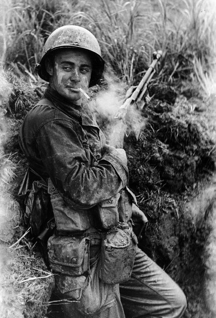 Dirt smeared American Marine Terry Moore soldier stopping for a cigarette break during the fight for Okinawa, 1945. (Photo by Carl Mydans/The LIFE Picture Collection/Getty Images)