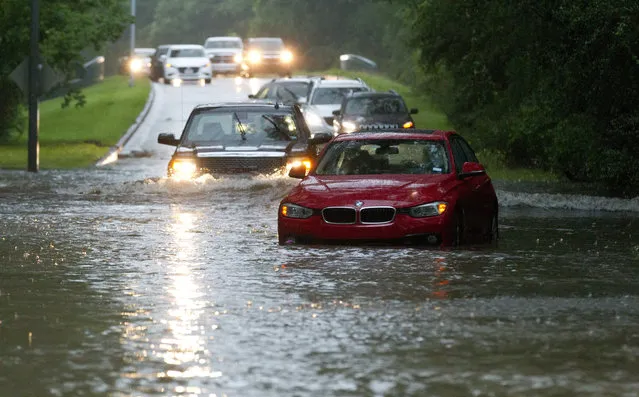 Vehicles wade through flooded Kingwood Drive as thunderstorms hit the Kingwood area Tuesday, May 7, 2019, in Kingwood, Texas. Heavy rain is battering parts of southeast Texas prompting flash flood warnings, power outages and calls for water rescues. (Photo by Jason Fochtman/Houston Chronicle via AP Photo)