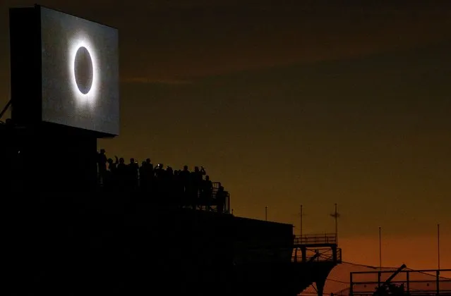 Spectators watch the total solar eclipse at Indianapolis Motor Speedway in Indianapolis, Indiana on April 8, 2024. (Photo by Mykal McEldowney/USA Today Network)