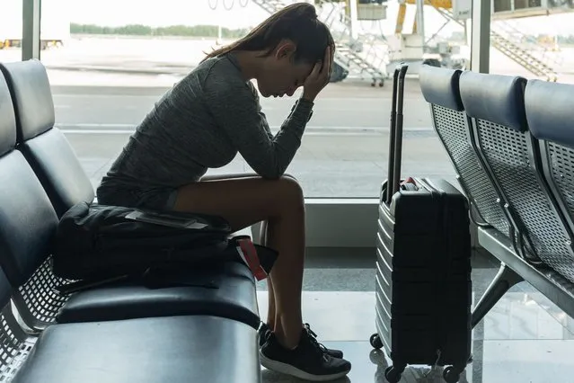 A passenger waiting at the airport terminal stressed out at tired. (Photo by globalmoments/Getty Images)