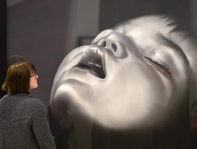 A visitor watches an  artwork by artist Robert Longo at the Art Cologne fair in Cologne, Germany, Friday, April 15, 2016. The world's oldest art fair for modern and contemporary art of the 20th and 21st century takes place in Cologne until Sunday. (Photo by Martin Meissner/AP Photo)