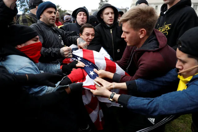 Counter-demonstrators (L) and supporters (R) of U.S. President Donald Trump fight for a U.S. flag during a “People 4 Trump” rally in Berkeley, California March 4, 2017. (Photo by Stephen Lam/Reuters)