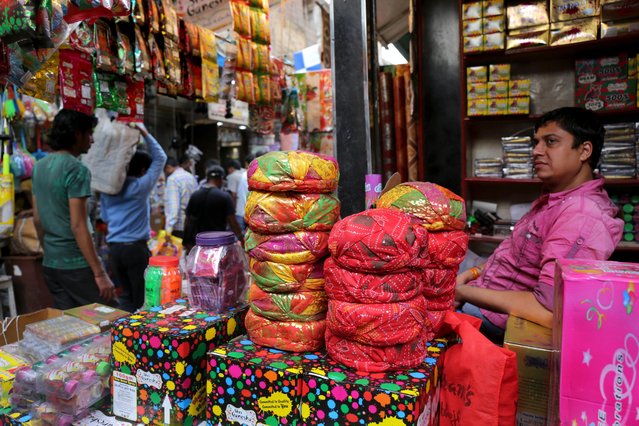 A street vendor offers colour guns and gulals or colour dust for sale at a local market ahead of the “Holi Festival” in Calcutta, eastern India, 06 March 2017. Holi festival is celebrated on the full moon day and marks the beginning of the spring season. Holi festival will be celebrated on 12 March. (Photo by Piyal Adhikary/EPA)
