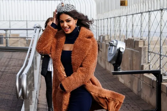 2021 Miss Universe Harnaaz Sandhu from India struggles to keep her crown on in the wind, as she arrives on the observation level of the Empire State Building in the Manhattan borough of New York City, New York, U.S. January 12, 2022. (Photo by Carlo Allegri/Reuters)