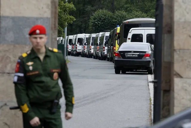 Buses carrying bodies of the 14 crew members who died in a fire on a Russian navy's deep-sea research submersible, drive to the Serafimovskoye memorial cemetery during a funeral ceremony in St. Petersburg, Russia, Saturday, July 6, 2019. Russian President Vladimir Putin has awarded the nation's highest honors to 14 seamen who died in a fire on one of the navy's research submersibles. (Photo by Dmitri Lovetsky/AP Photo)