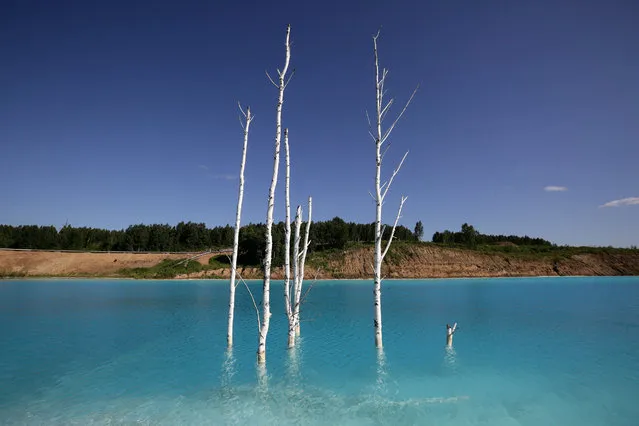 A view of a Novosibirsk energy plant's ash dump site – nicknamed the local “Maldives” – on July 11, 2019. An industrial dump site in Siberia whose turquoise lake resembles a tropical paradise has become a magnet for Instagrammers who risk their health in the toxic water to wow online followers. (Photo by Rostislav Netisov/AFP Photo)