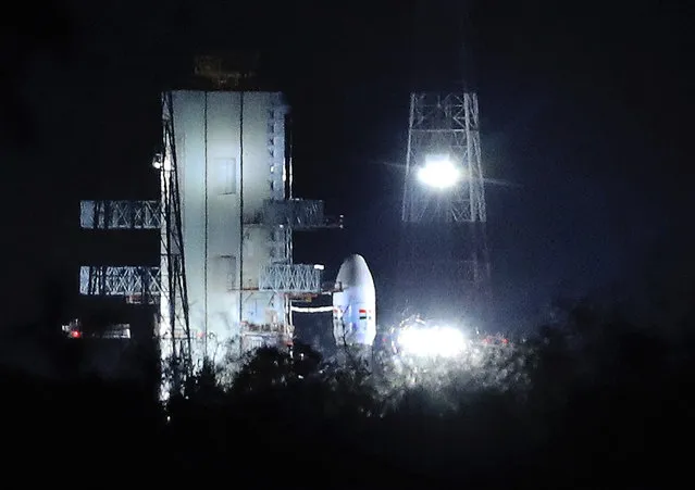 Indian Space Research Organization (ISRO)'s Geosynchronous Satellite launch Vehicle (GSLV) MkIII carrying Chandrayaan-2 stands at Satish Dhawan Space Center after the mission was aborted at the last minute at Sriharikota, in southern India, Monday, July 15, 2019. India has called off the launch of a moon mission to explore the lunar south pole. The Chandrayaan-2 mission was aborted less than an hour before takeoff on Monday. An Indian Space Research Organization spokesman says a “technical snag” was observed in the 640-ton launch-vehicle system. (Photo by Manish Swarup/AP Photo)