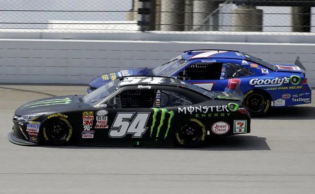 Erik Jones (54) drives past Regan Smith (7) during the NASCAR Xfinity series auto race at Chicagoland Speedway, Sunday, June 21, 2015, in Joliet, Ill. (AP Photo/Nam Y. Huh) 