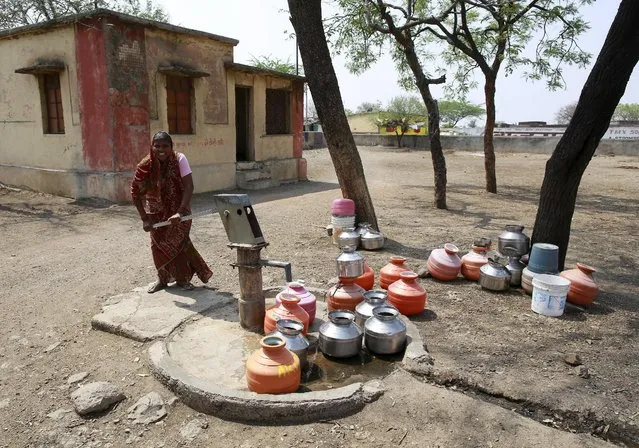 Fatima Mulani uses a hand-pump to collect water at a Primary Health Centre in Latur, India, April 16, 2016. (Photo by Danish Siddiqui/Reuters)