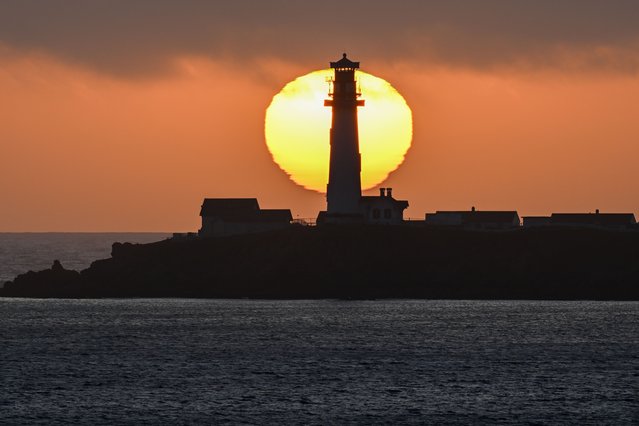 Sun sets behind the Pigeon Point Lighthouse in Pescadero, California, United States on May 26, 2024. Pigeon Point Lighthouse was built in 1871 to guide ships on the Pacific coast of California. (Photo by Tayfun Coskun/Anadolu via Getty Images)
