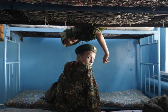 Students from the General Yermolov Cadet School sit on bunk beds during a two-day field exercise near the village of Sengileyevskoye, just outside the south Russian city of Stavropol April 12, 2014. (Photo by Eduard Korniyenko/Reuters)