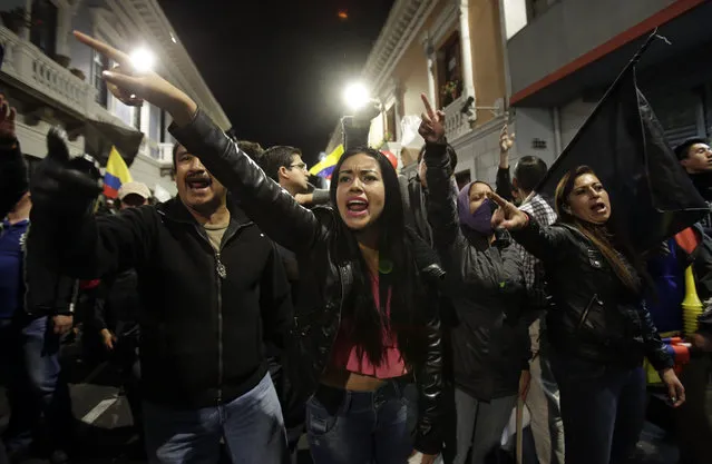 Protesters shout slogans against President Rafael Correa during an opposition march to the president's office in Quito, Ecuador, late Thursday, July 2, 2015. People turned out for protest marches across Ecuador to call for Correa's ouster just three days before a visit by Pope Francis. (Photo by Dolores Ochoa/AP Photo)
