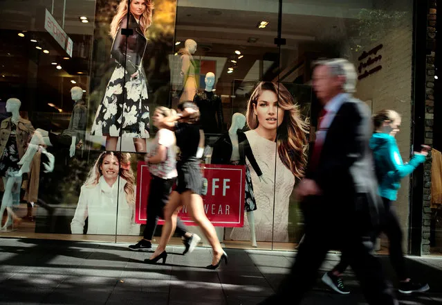 Shoppers walk past a fashion store in Sydney's central retail district, Australia, May 5, 2016. (Photo by Jason Reed/Reuters)