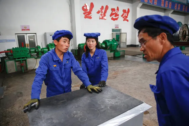 Workers chat during a government organised visit for foreign reporters to the Pyongyang 326 Electric Cable Factory in Pyongyang, North Korea May 6, 2016. (Photo by Damir Sagolj/Reuters)