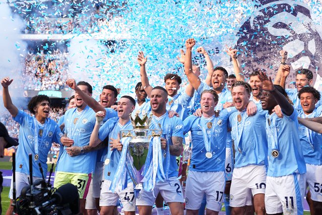 Manchester City's Kyle Walker lifts the Premier League trophy with team-mates after the Premier League match at the Etihad Stadium, Manchester on Sunday, May 19, 2024. (Photo by Martin Rickett/PA Wire)