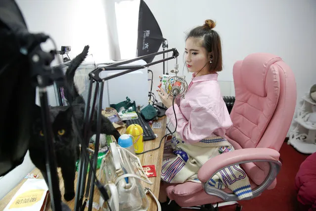 A girl broadcasts at live streaming talent agency Three Minute TV in Beijing, China on April 12, 2017. Three Minute TV also arranges cosmetic surgery at partner hospitals for its anchors, arranges small bank loans for the surgery, photographs and markets the anchors and helps them find acting opportunities Deng said. (Photo by Damir Sagolj/Reuters)