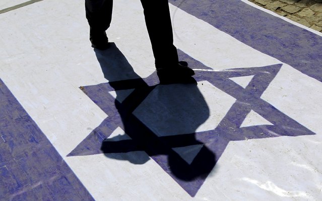 A demonstrator steps on an Israeli flag during a rally marking al-Quds (Jerusalem) Day in Tehran July 10, 2015. (Photo by Reuters/Stringer/TIMA)