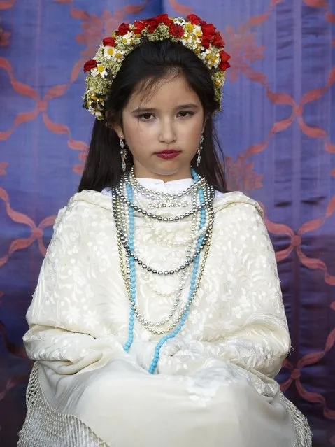 A “Maya” girl sits in an altar during the traditional celebration of “Las Mayas” on the streets in Colmenar Viejo, near Madrid, Spain, Friday, May 2, 2014. (Photo by Daniel Ochoa de Olza/AP Photo)