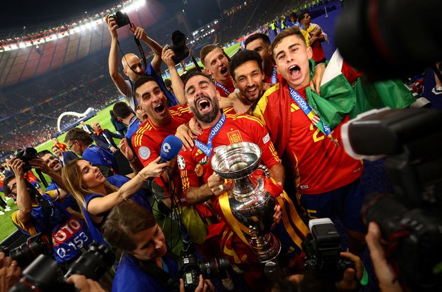 Spain's Dani Carvajal, Ferran Torres, Jesus Navas, Fermin Lopez and teammates celebrate with the trophy after winning the UEFA Euro 2024 Final match at the Olympiastadion in Berlin on July 14, 2024. (Photo by Kai Pfaffenbach/Reuters)