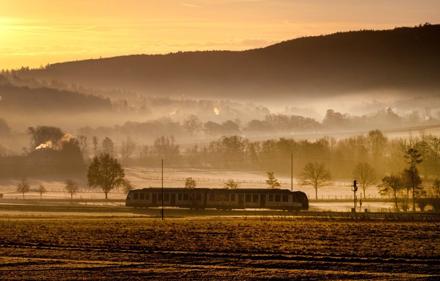 A regional train approaches the station of Wehrheim near Frankfurt, Germany, on a misty Tuesday morning, February 13, 2024. (Photo by Michael Probst/AP Photo)