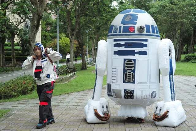 Star Wars fans appear in costumes at a local park to mark a “May the 4th be with you” event in Taipei on May 4, 2022. (Photo by Sam Yeh/AFP Photo)
